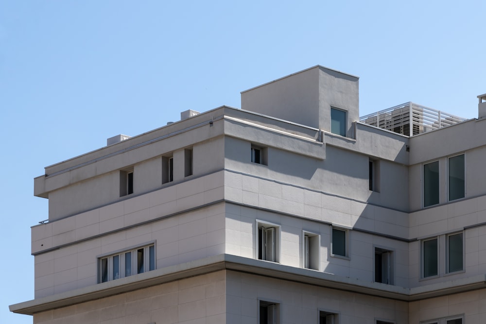 a tall building with windows and a sky background