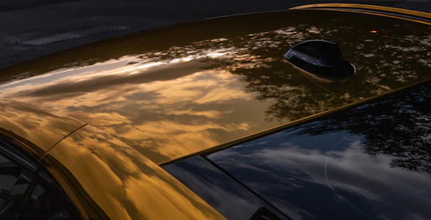 Before and after shots of a car roof damaged by hail, now perfectly restored.