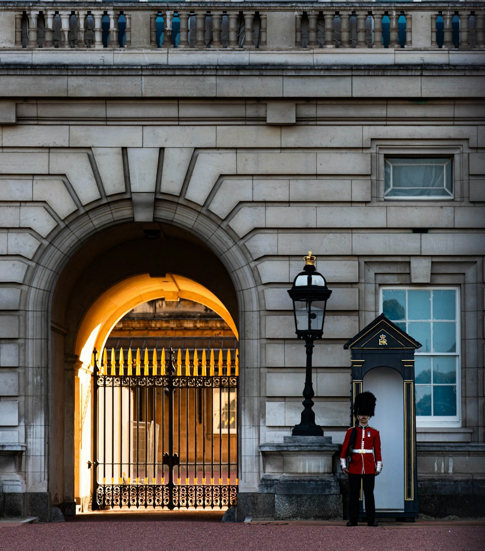 a guard stands in front of a gated entrance