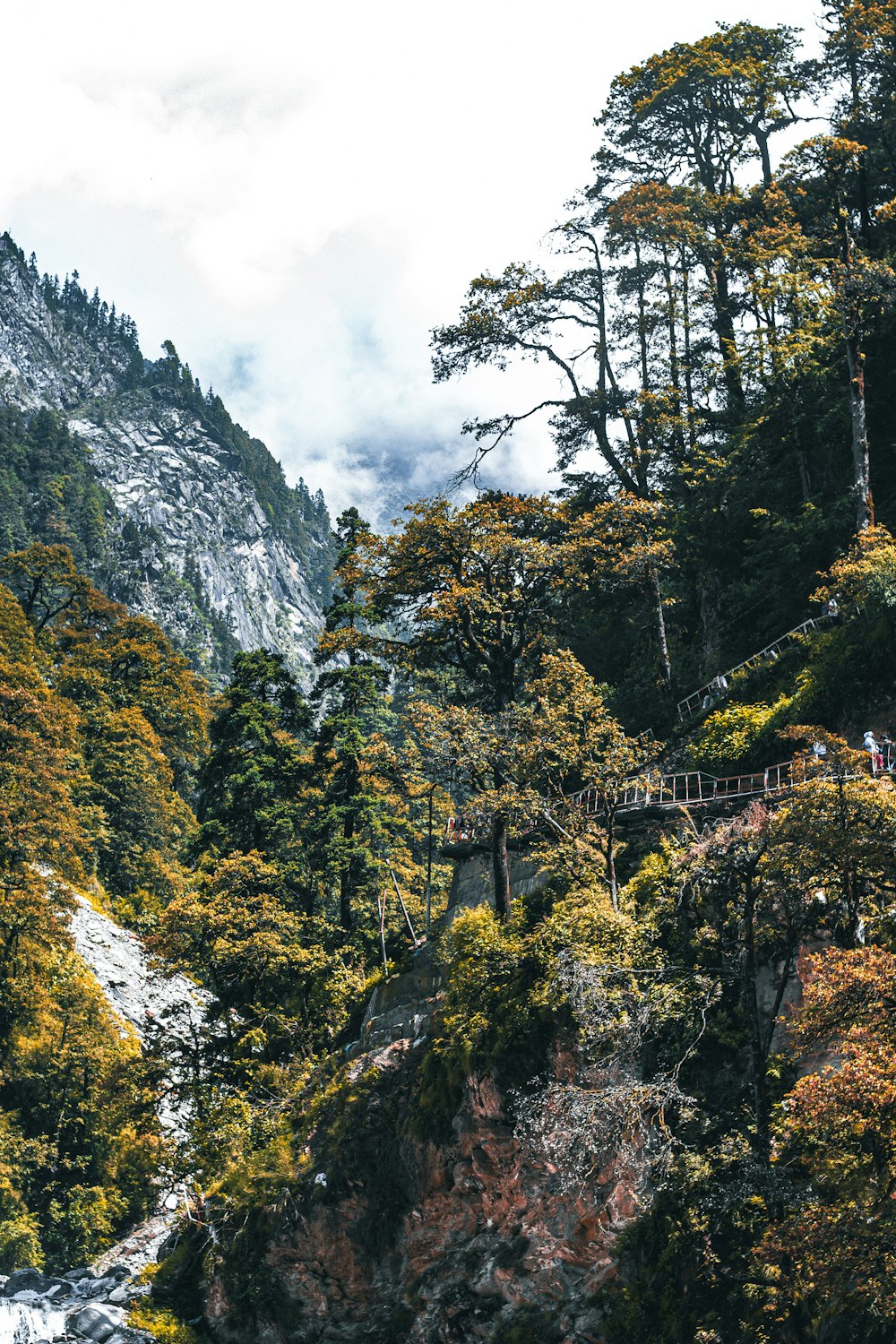 a scenic view of a mountain with a bridge in the middle