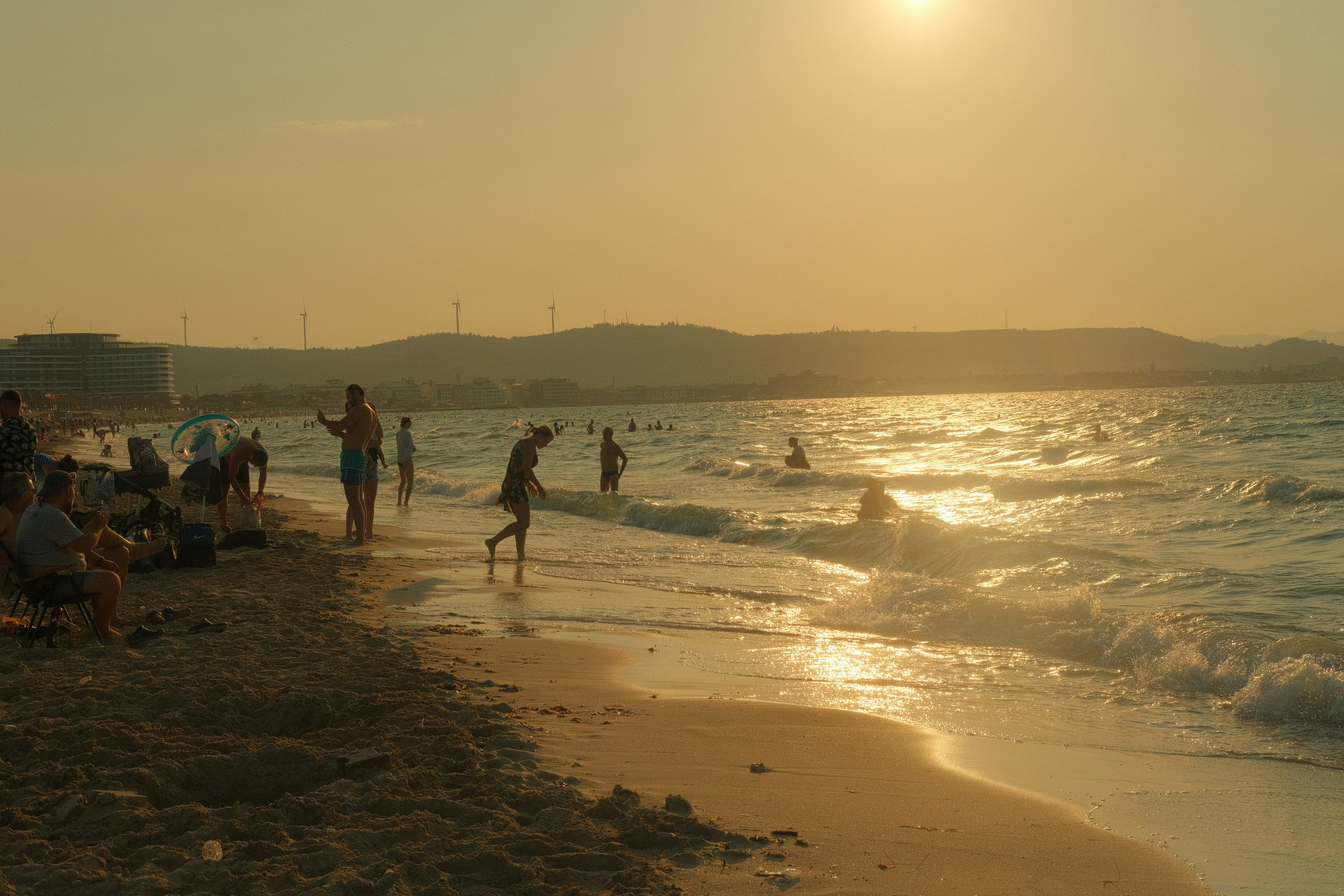 a group of people standing on top of a sandy beach