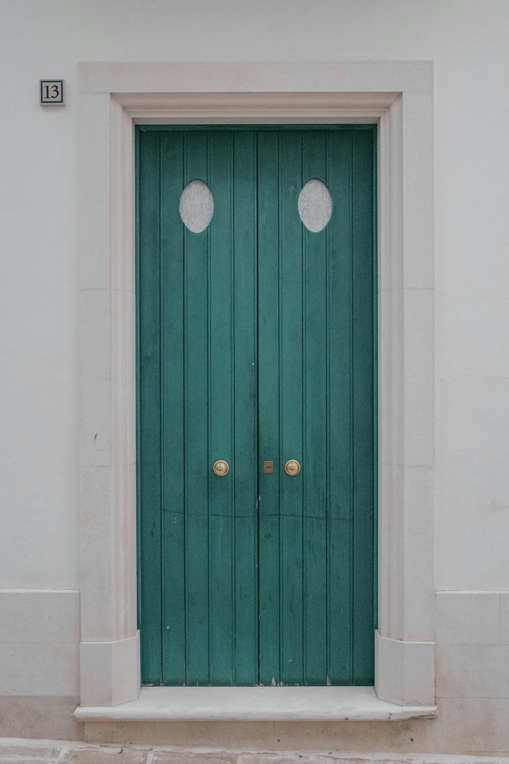 a green door with two round knobs on it