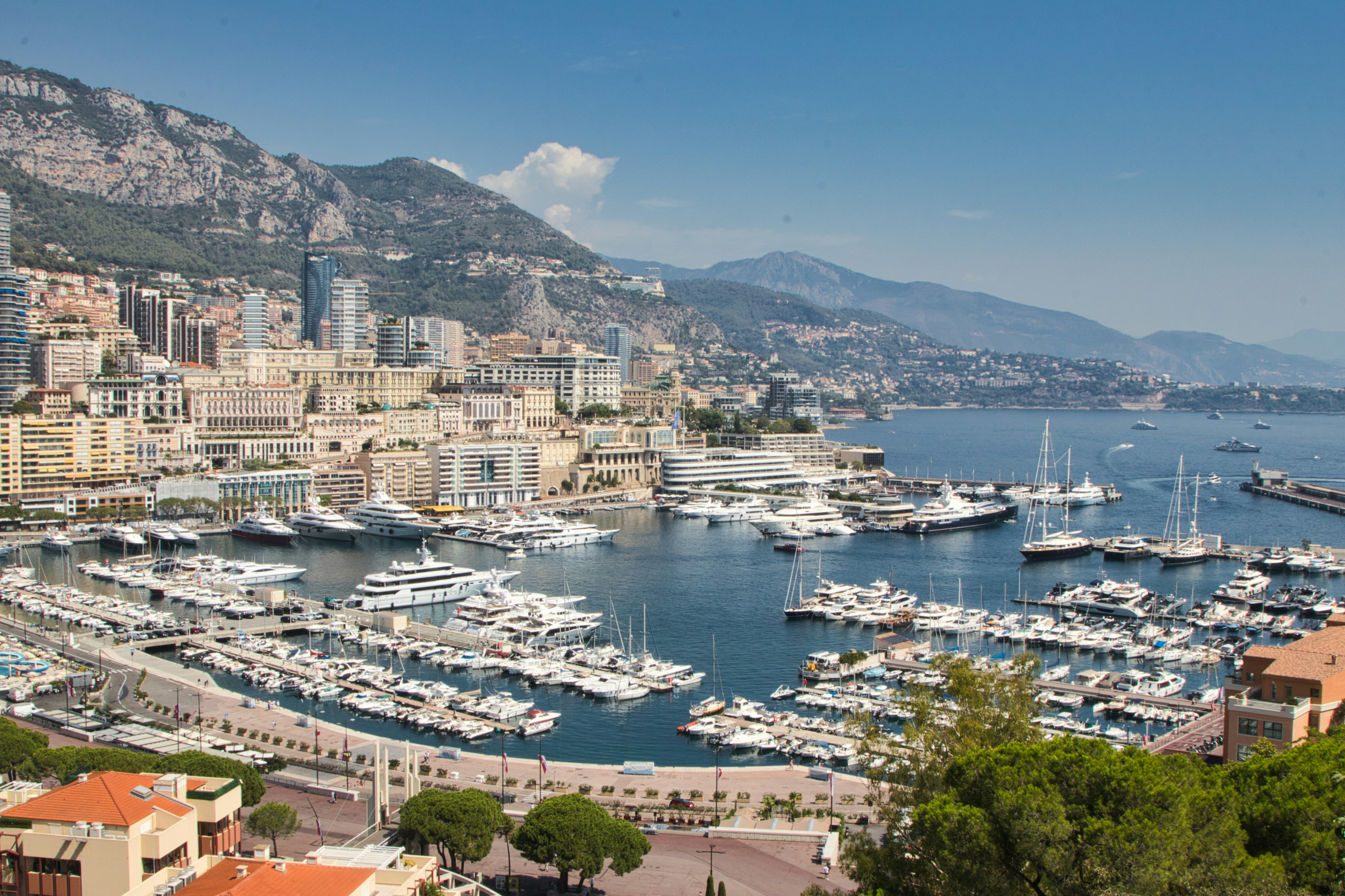 a harbor filled with lots of boats next to a city