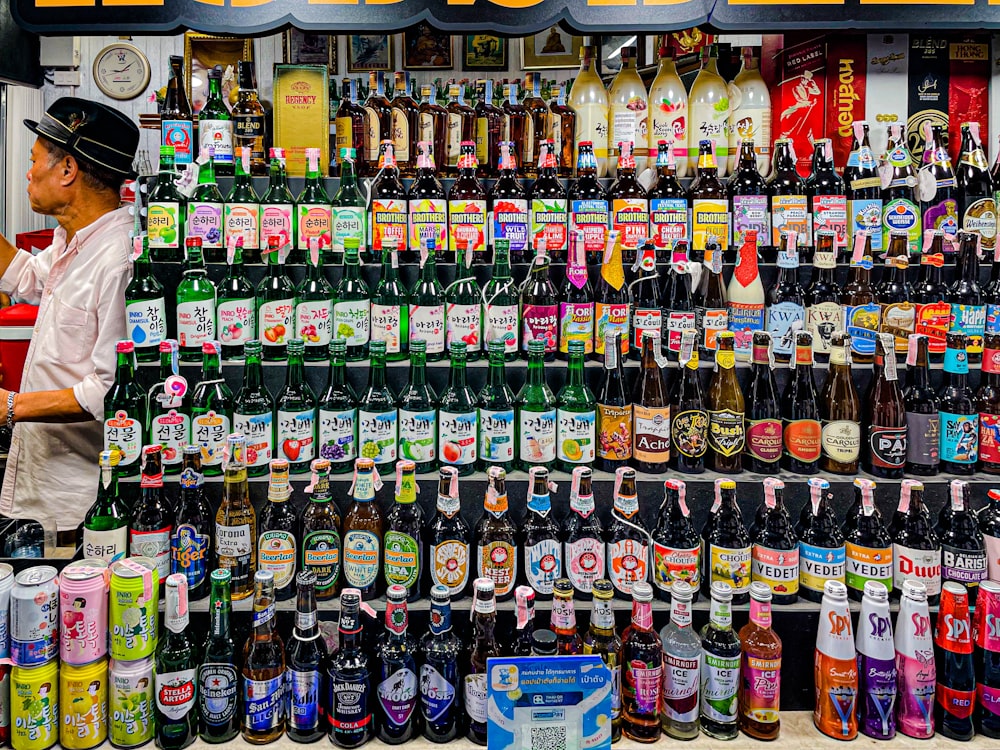 a man standing in front of a display of beer bottles