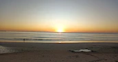 Chennai’s Marina Beach at sunrise with soft waves and early morning walkers.