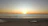 A serene image of a person meditating at sunrise on a quiet beach.