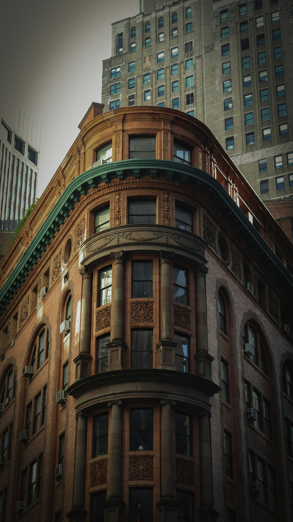 an old building with a green roof in the city