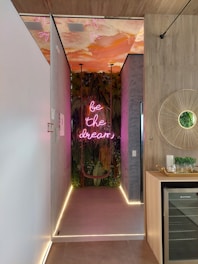 a long hallway with a neon sign on the wall