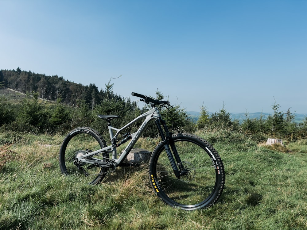 a mountain bike parked on a grassy hill