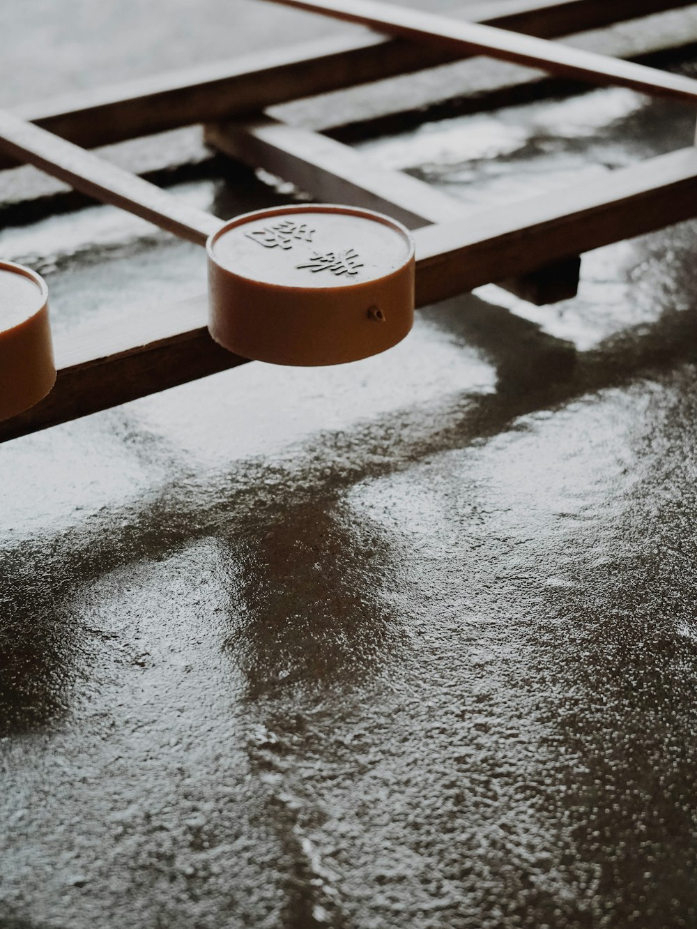 a close up of a metal object on a wet surface