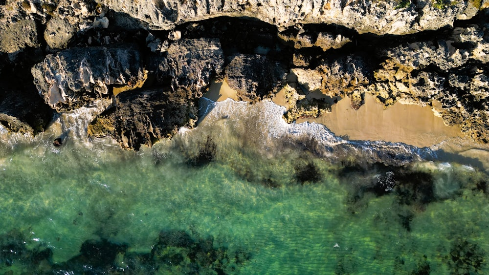 an aerial view of the water and rocks