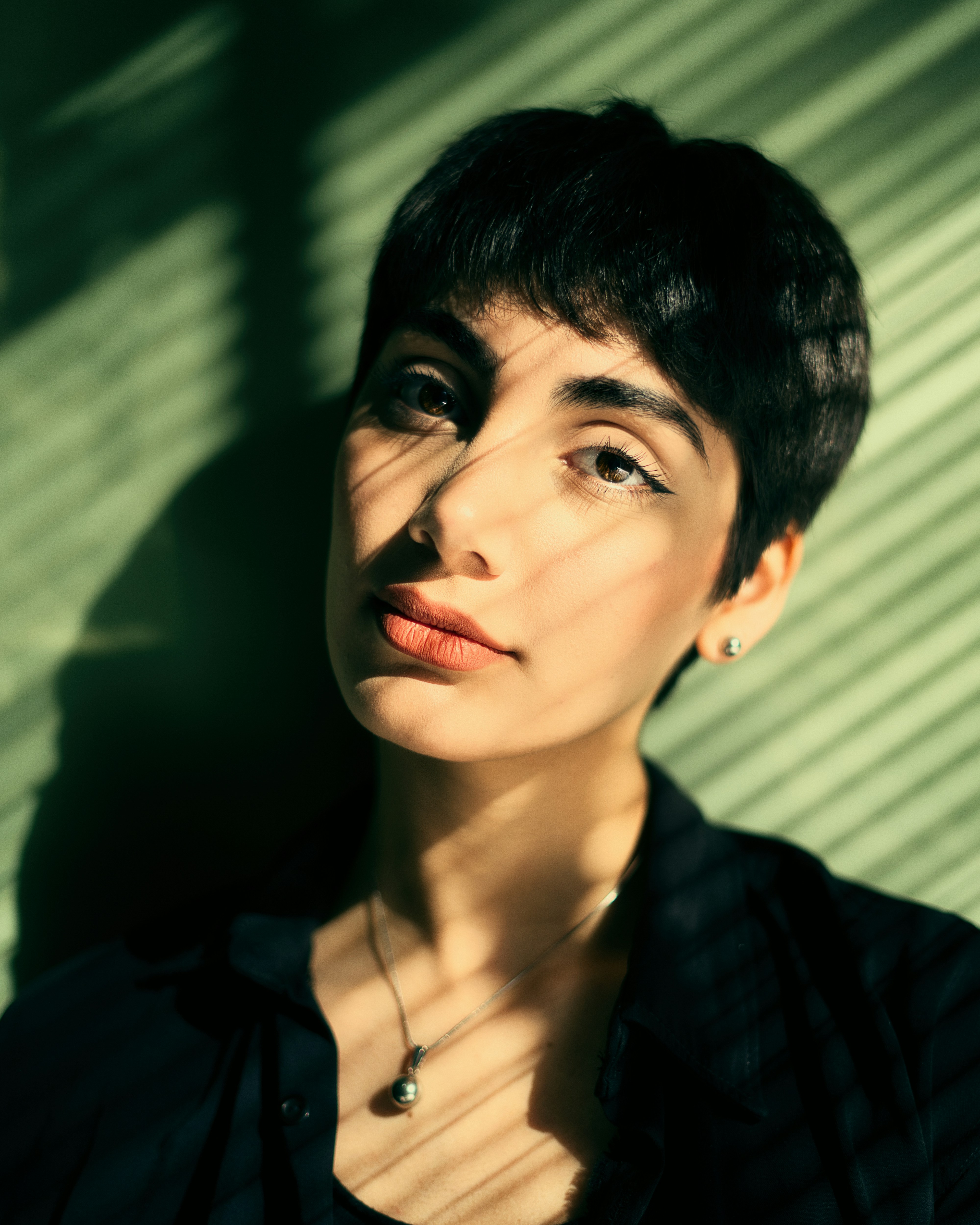 a woman with short hair and a black shirt