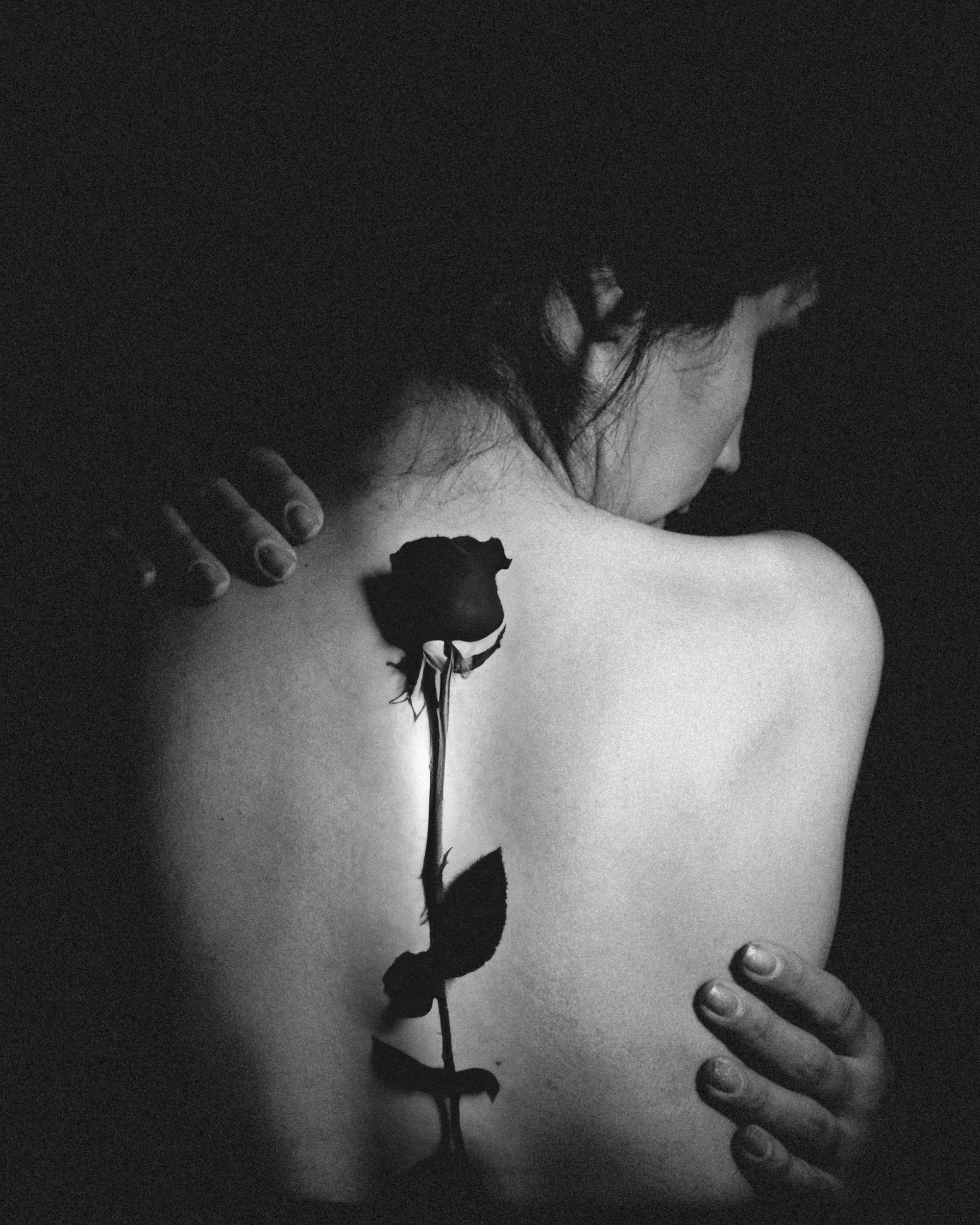 a woman with a rose tattoo on her back