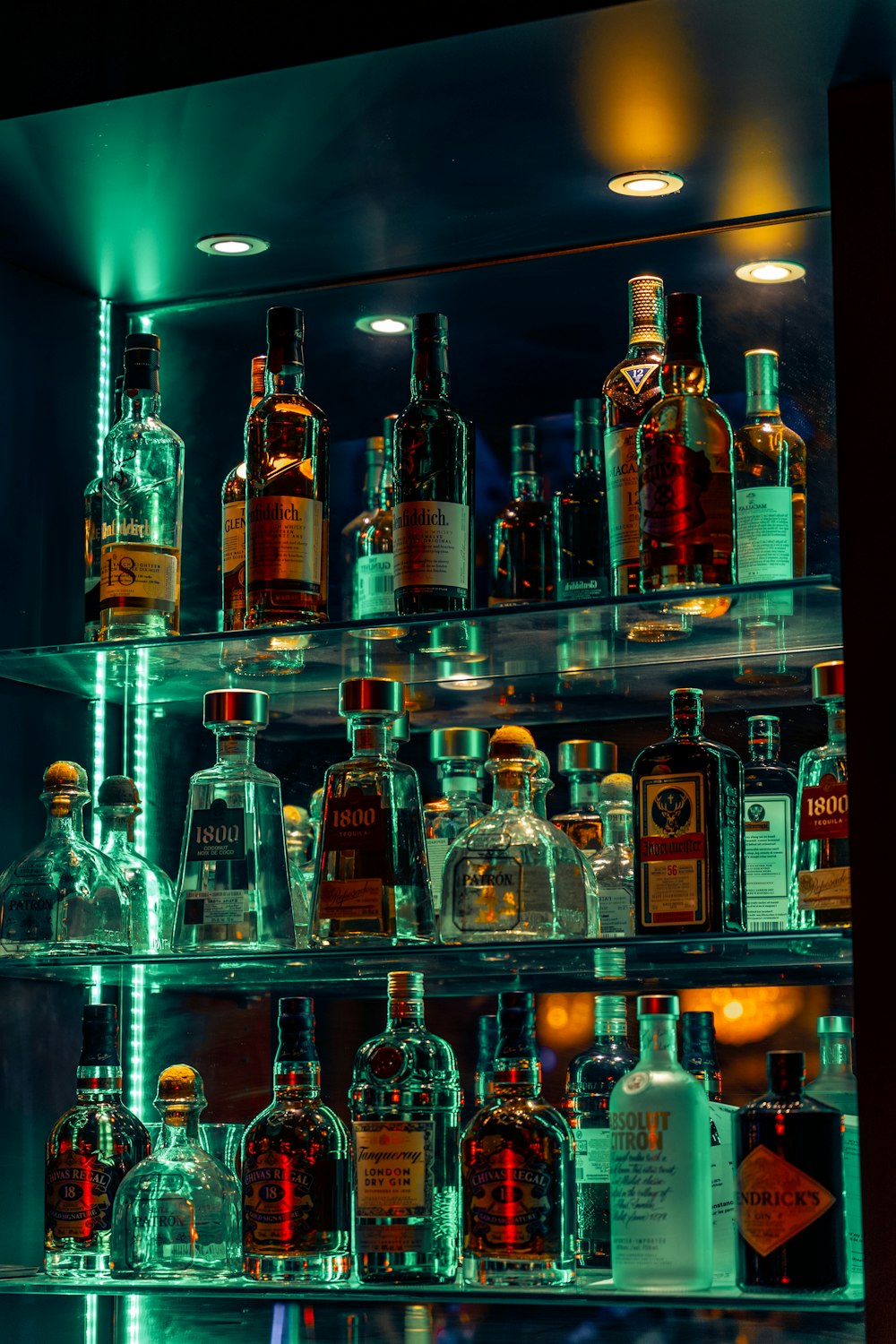 a shelf filled with lots of bottles of liquor