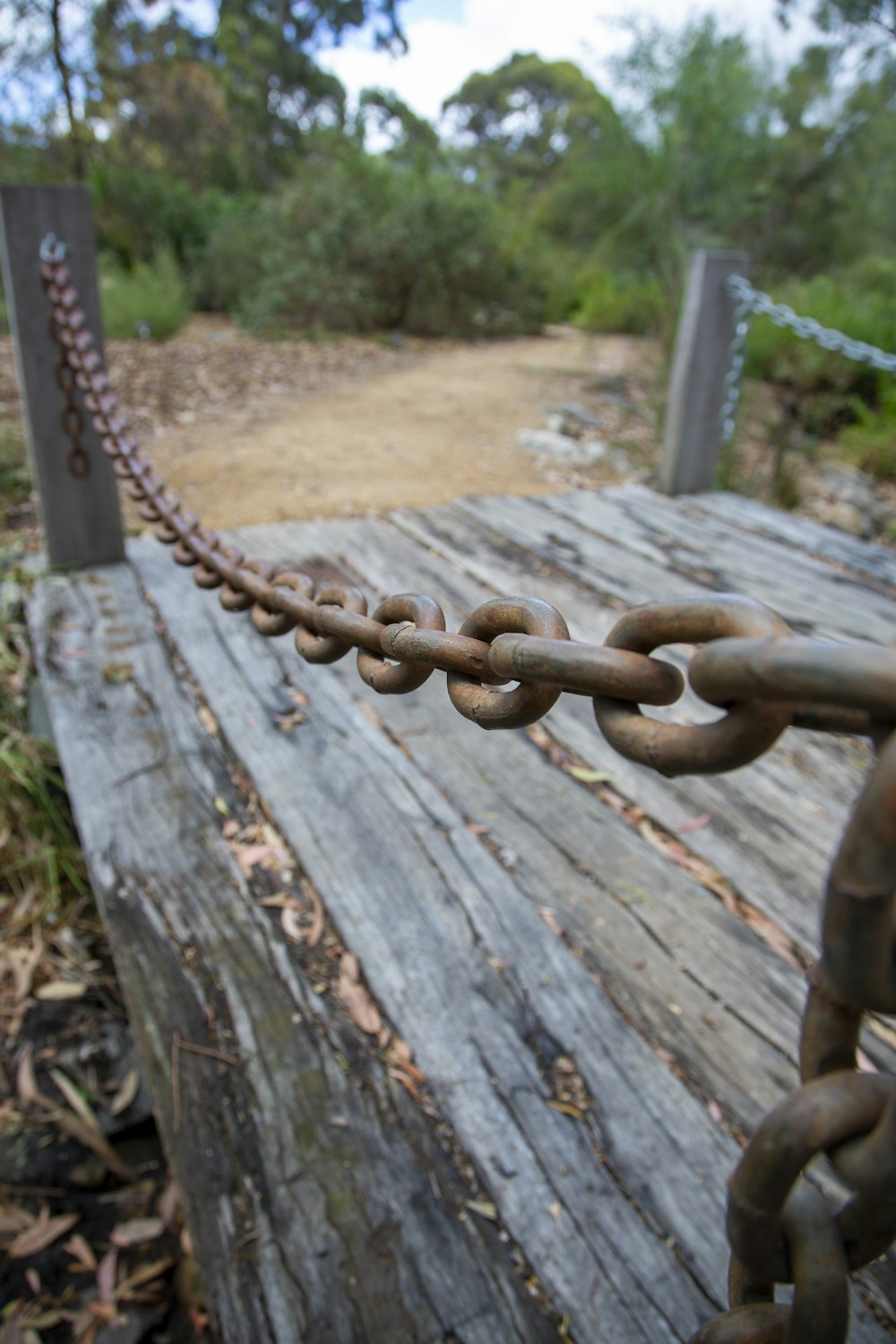 a chain is attached to a wooden bench