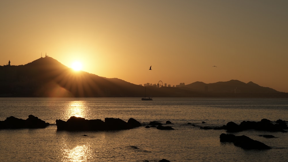 a large body of water with a mountain in the background