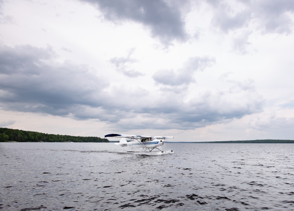 a small plane is traveling across the water