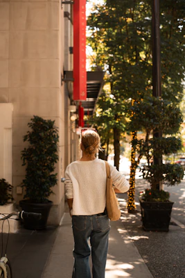 A cozy knit sweater paired with classic jeans on a sunny morning walk