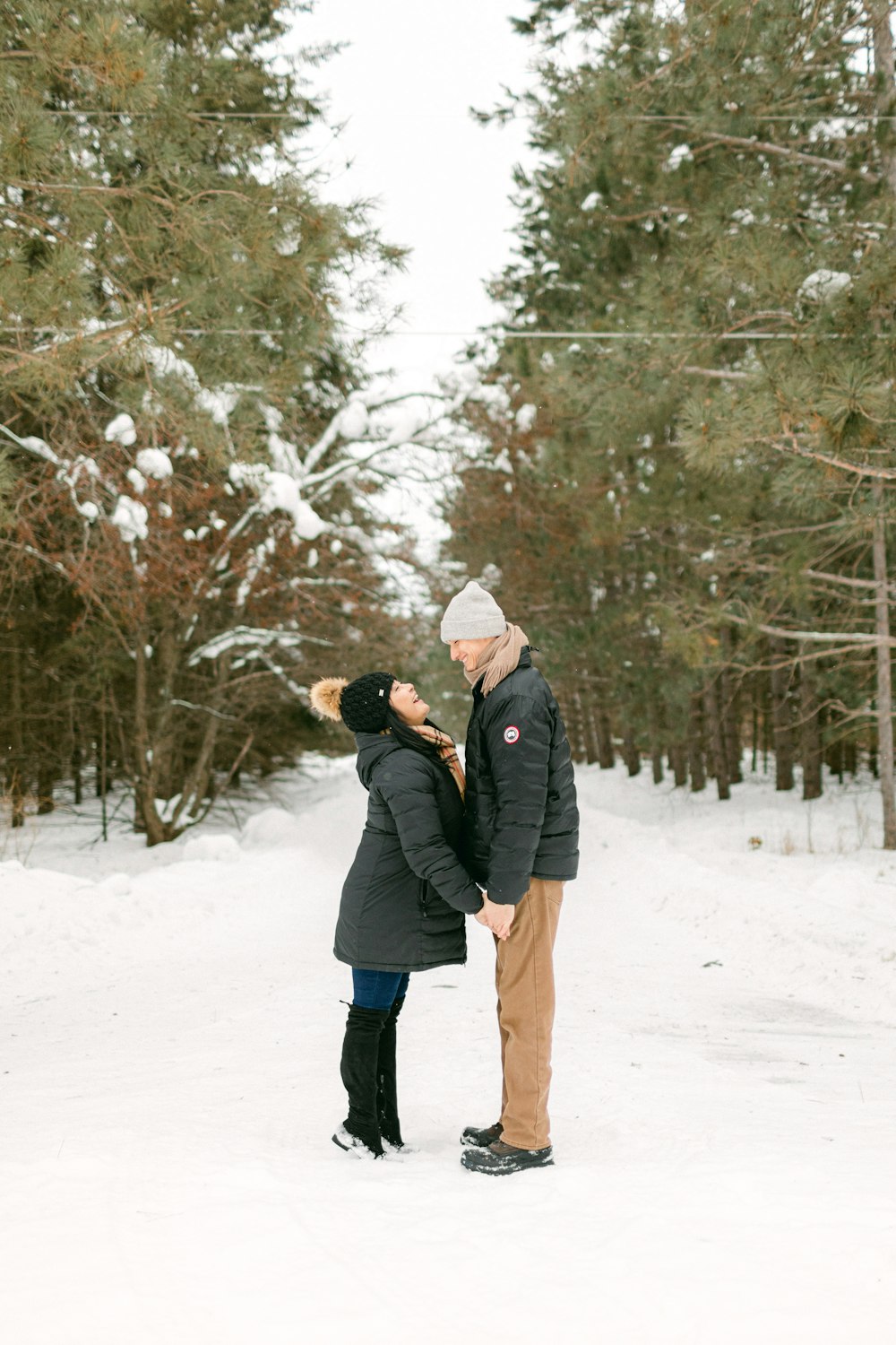 a man and a woman standing in the snow