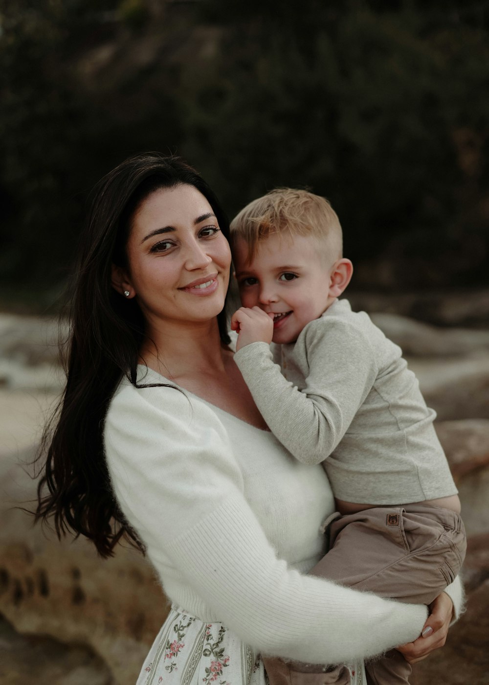 a woman holding a small child in her arms