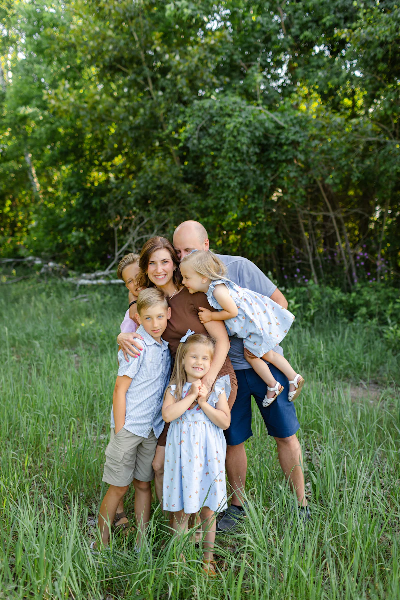 A family posing together in a field