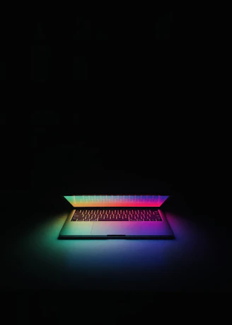a laptop is lit up in the dark