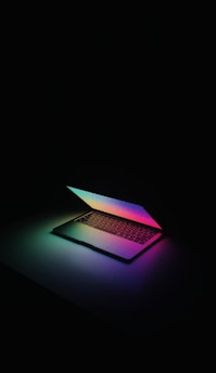 a laptop computer sitting on top of a table
