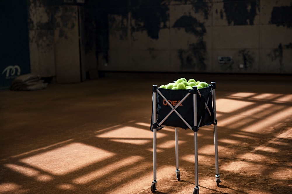 a basket of green apples sitting on top of a table