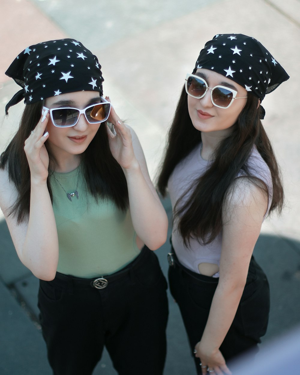 two girls with sunglasses and stars on their hats