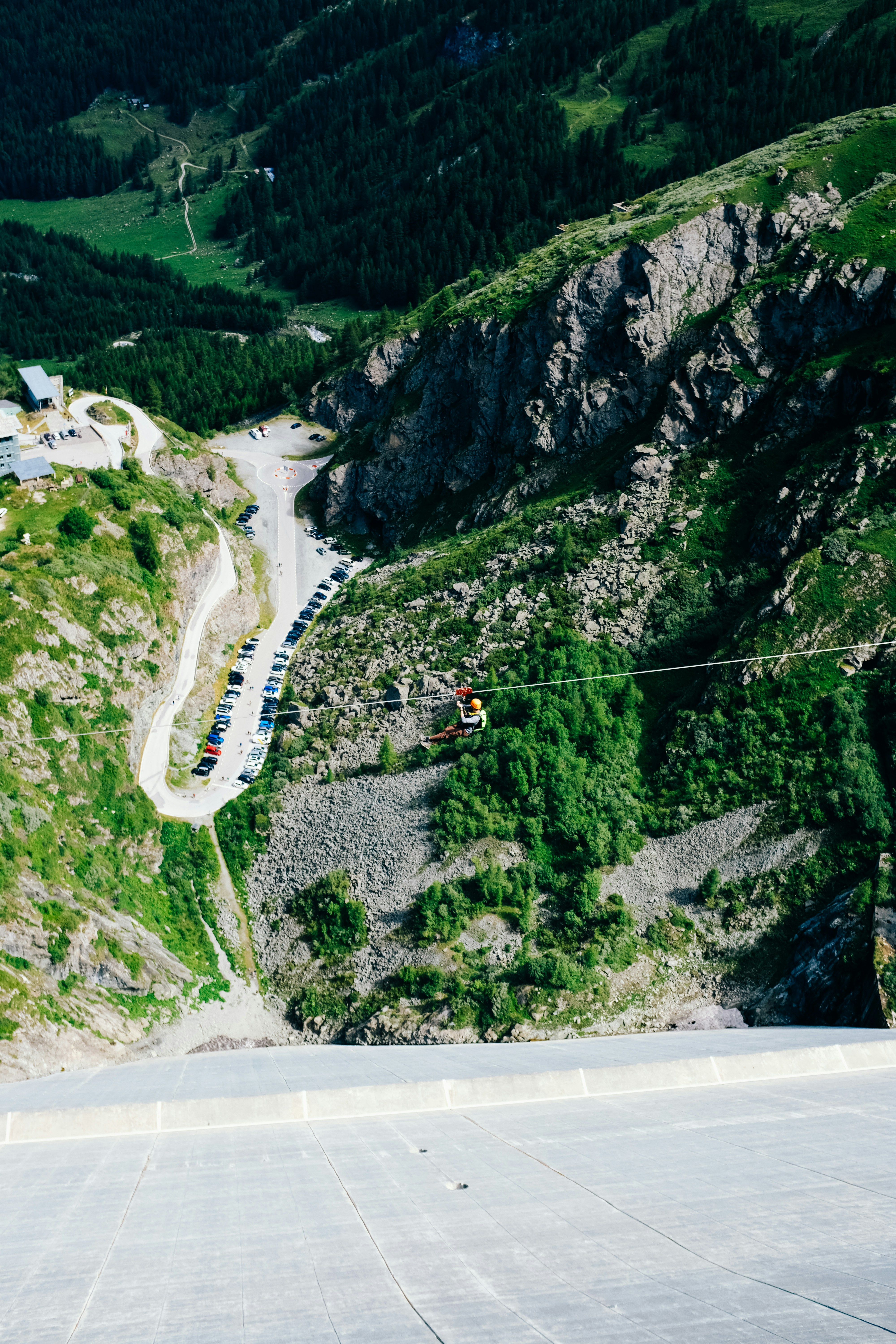 A person on a rope in the middle of a mountain photo – Free Land Image ...