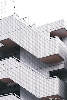 Geometric architectural design featuring a series of outdoor staircases with tiled surfaces, characterized by clean lines and a minimalist aesthetic.