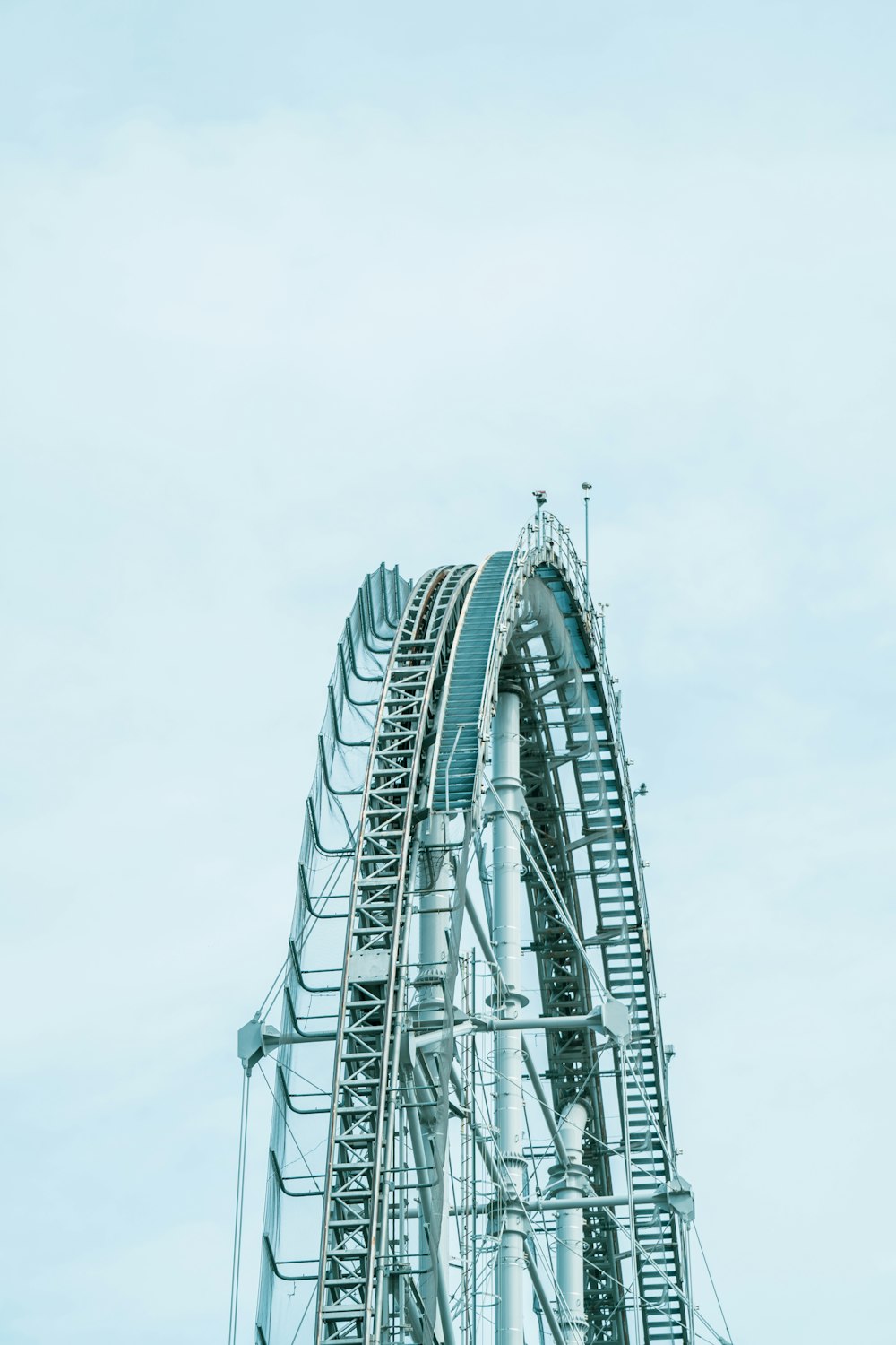 a roller coaster going down a hill on a cloudy day