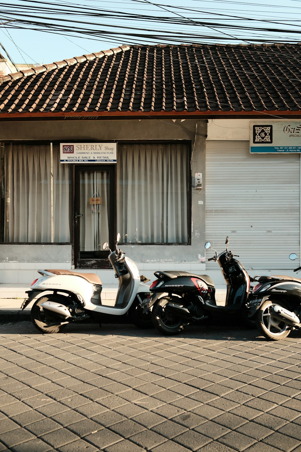 two motorcycles parked in front of a building