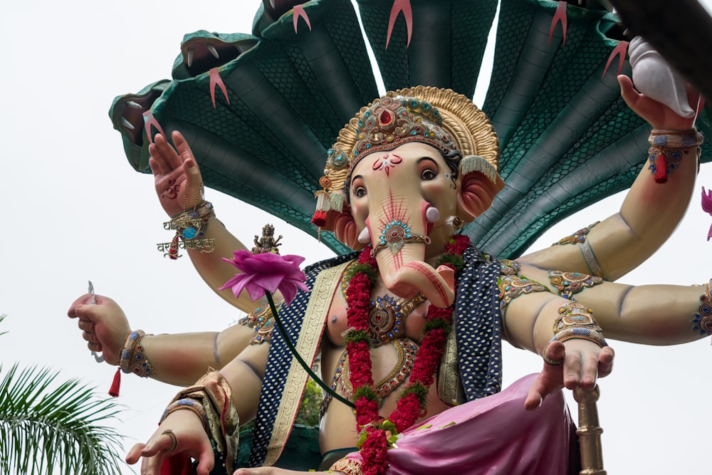 a statue of an elephant with a fan on its head