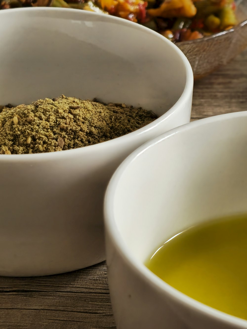 a couple of bowls filled with food on top of a wooden table