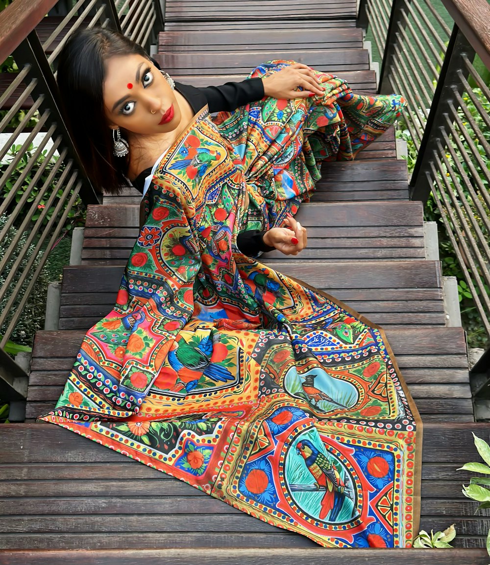 a woman is sitting on a wooden staircase