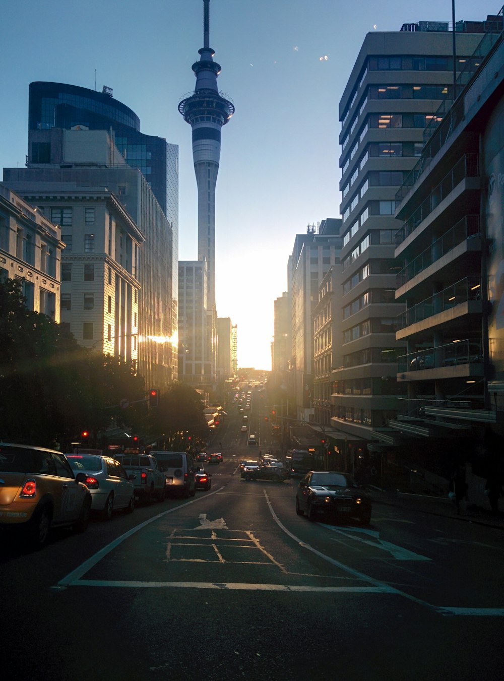 a city street filled with lots of traffic and tall buildings