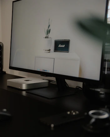 Sleek compact desktop air purifier glowing softly on a modern office desk.