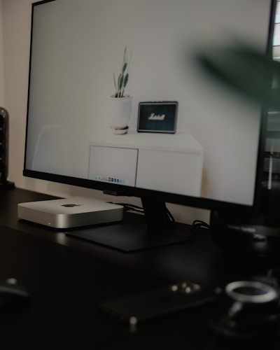 A sleek, modern computer monitor displaying vibrant graphics on a minimalist desk setup.