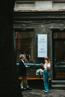 A smiling client holding their new Georgian SIM card outside a local shop.