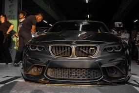 a black car with gold trim parked in a garage