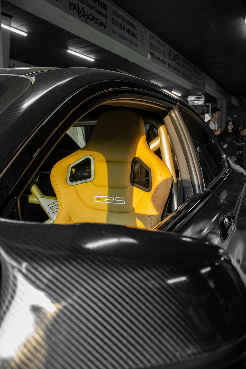a black and yellow sports car parked in a garage