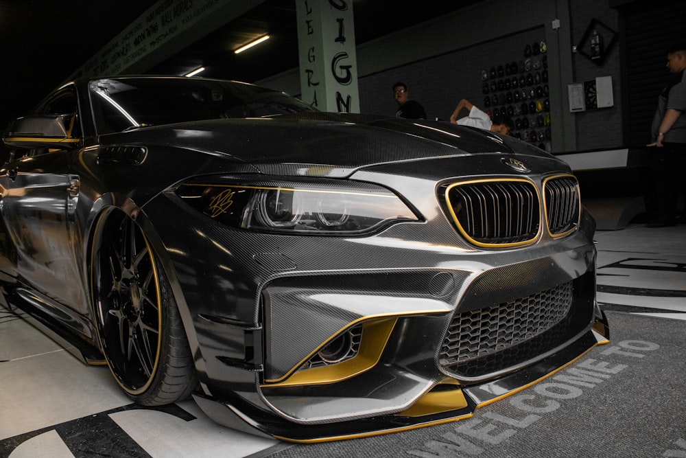 a black and gold car parked in a garage
