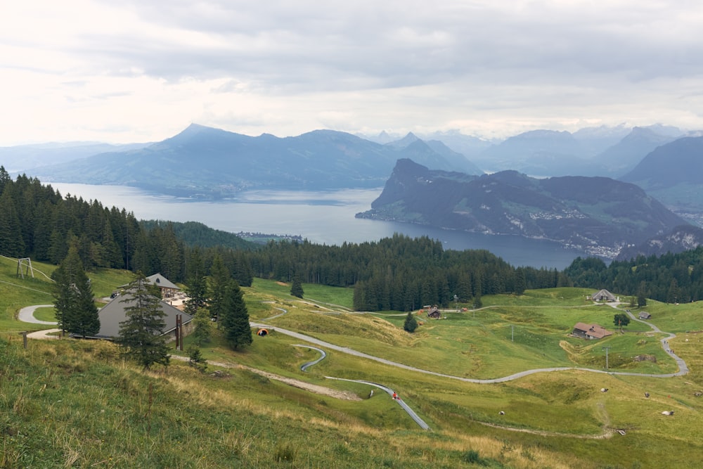 a scenic view of a mountain with a lake in the distance