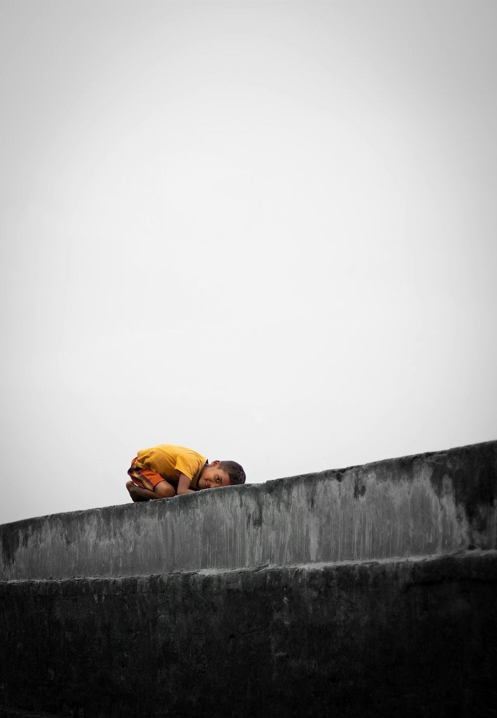 a person laying down on a cement wall