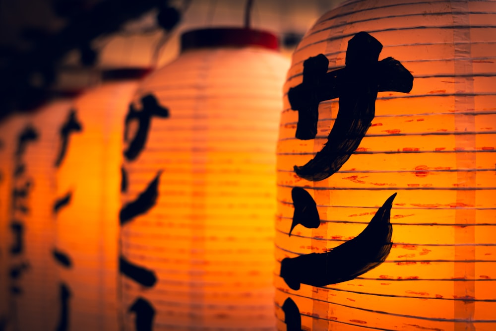 a row of lanterns with asian writing on them