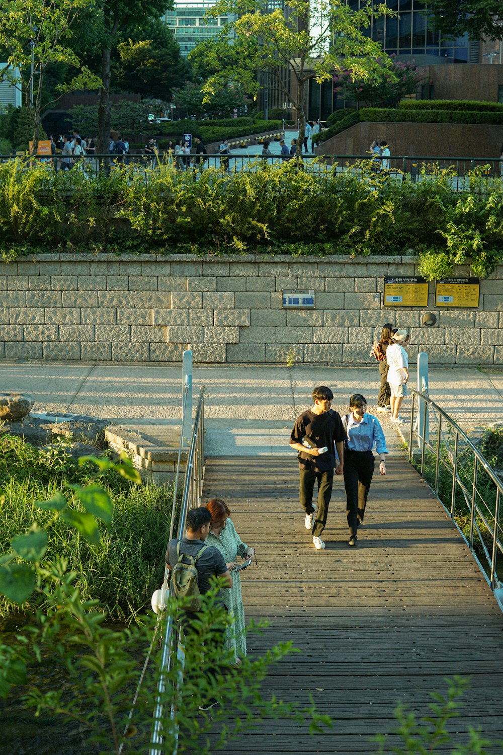 a group of people walking across a bridge