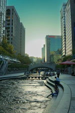 a river running through a city next to tall buildings