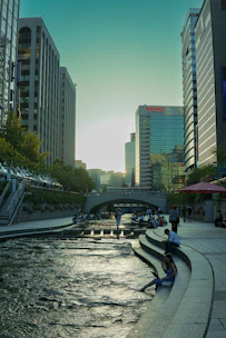 a river running through a city next to tall buildings