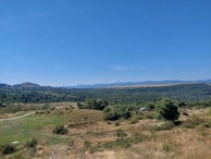 A panoramic view of Kangaroo Valley with a Bluepeak Digital vehicle parked at a lookout, capturing the lush green landscape.